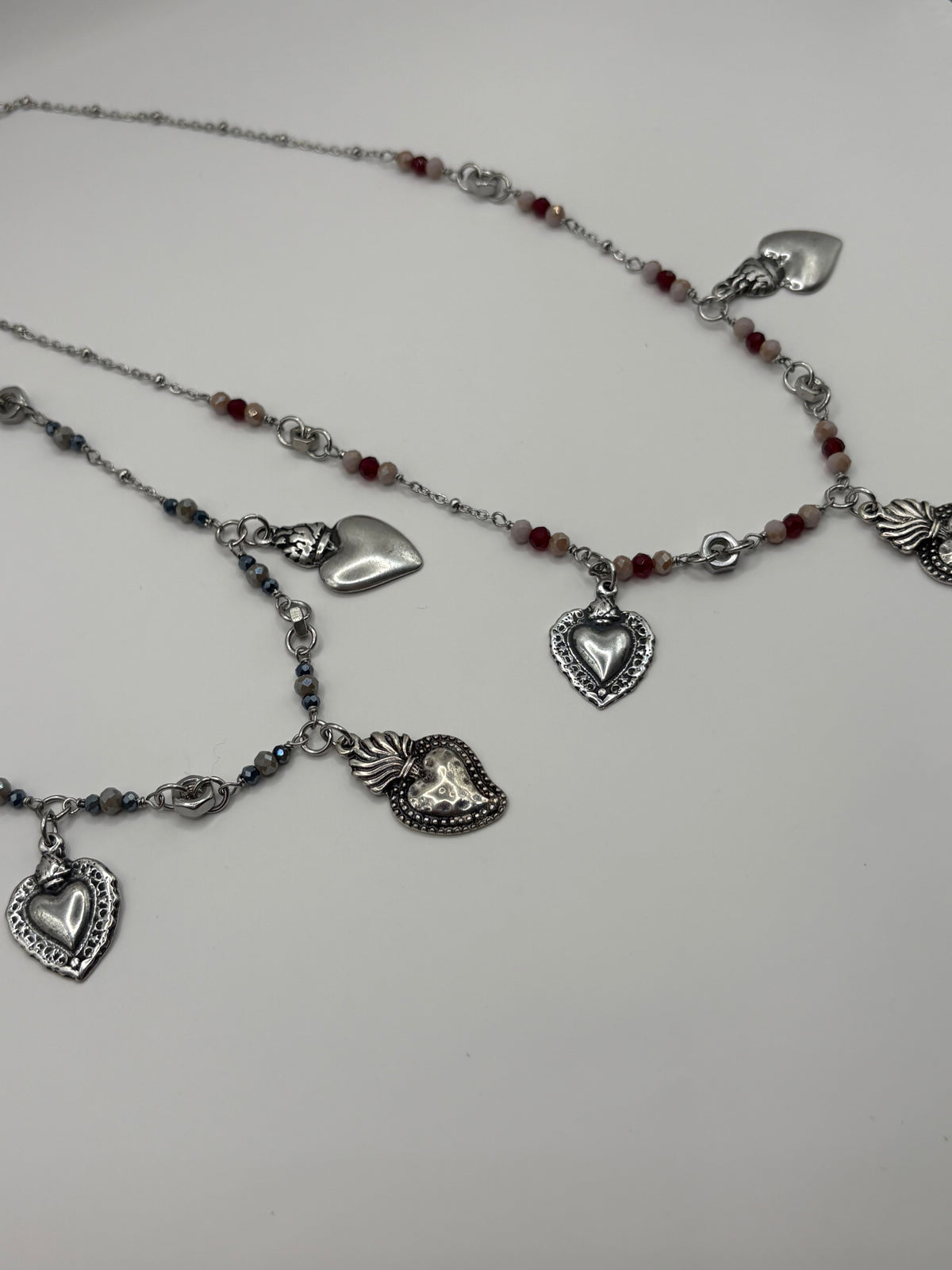 Collana TreCuori in acciaio con cuori sacri e cristalli